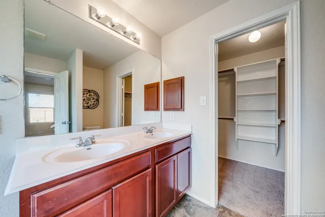 a bathroom with a sink double vanity and a mirror