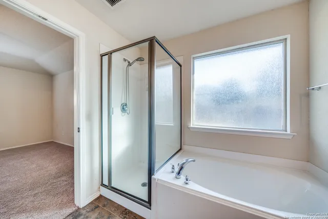 a bathroom with a bathtub and a shower