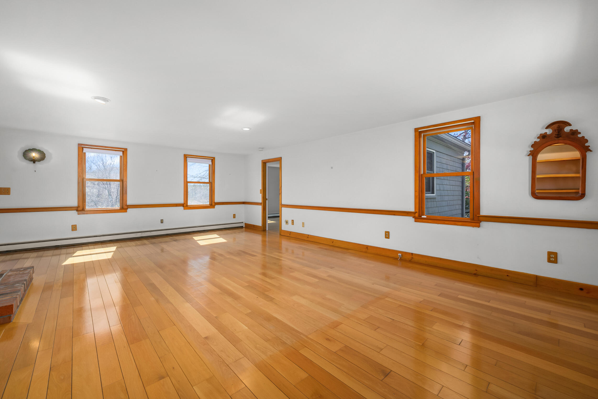 181 Elliott Road Centerville, MA 02632 - Photo 11 of 60 a view of an empty room with window and wooden floor