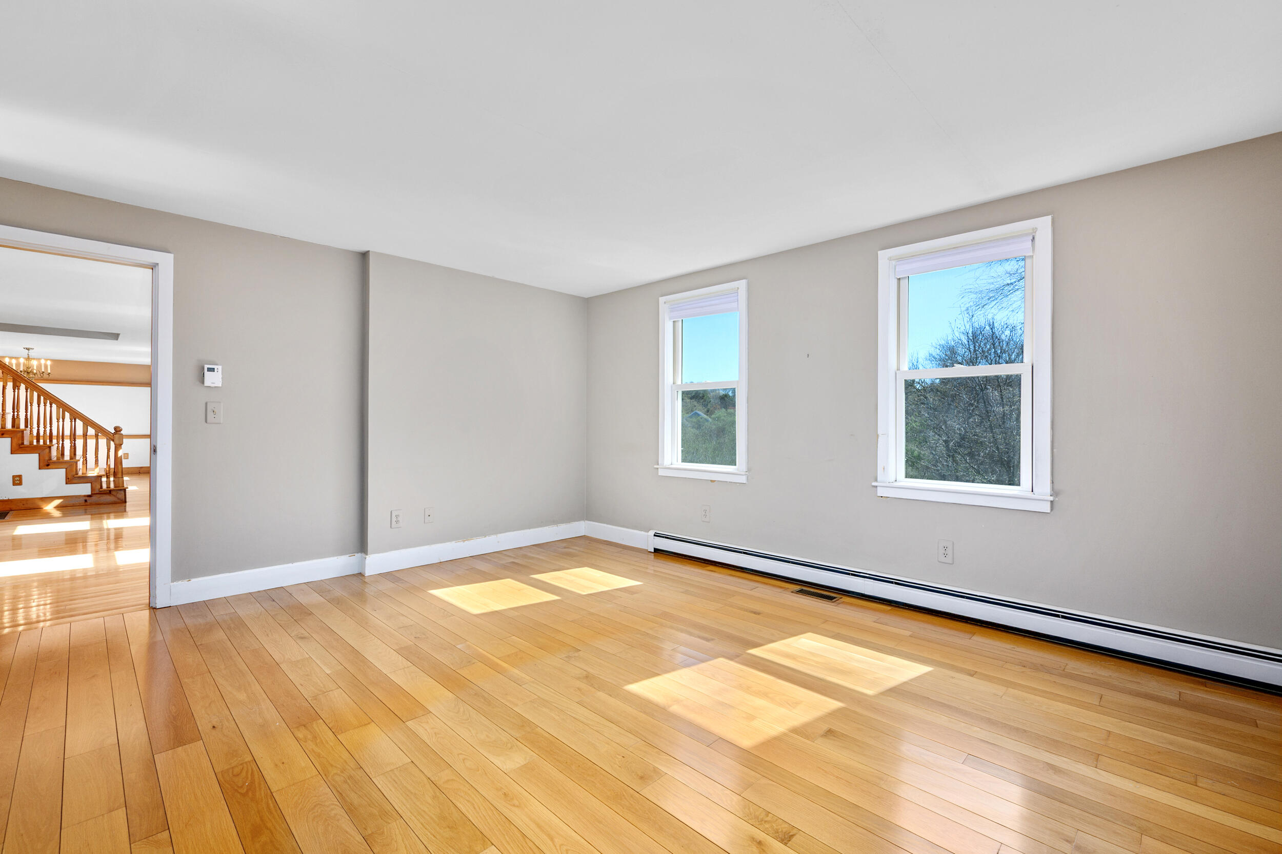 181 Elliott Road Centerville, MA 02632 - Photo 26 of 60 a view of an empty room with wooden floor and a window