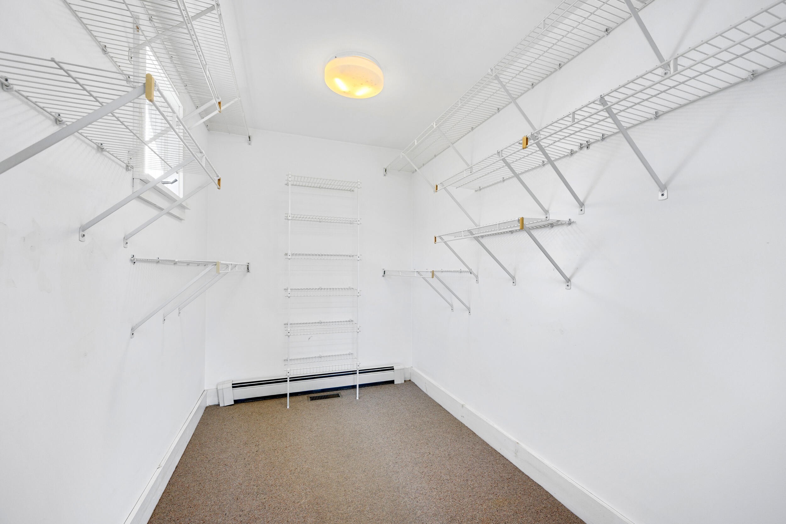 181 Elliott Road Centerville, MA 02632 - Photo 28 of 60 a view of a room with racks on the wall