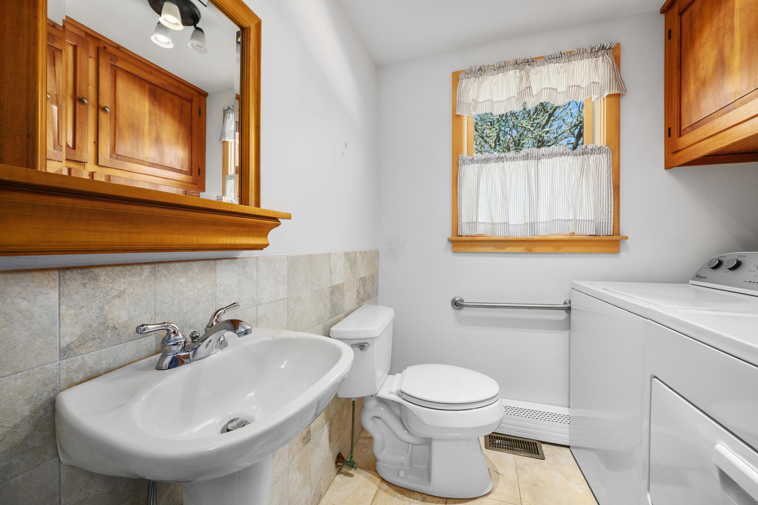 181 Elliott Road Centerville, MA 02632 - Photo 29 of 60 a bathroom with a sink a mirror and a toilet