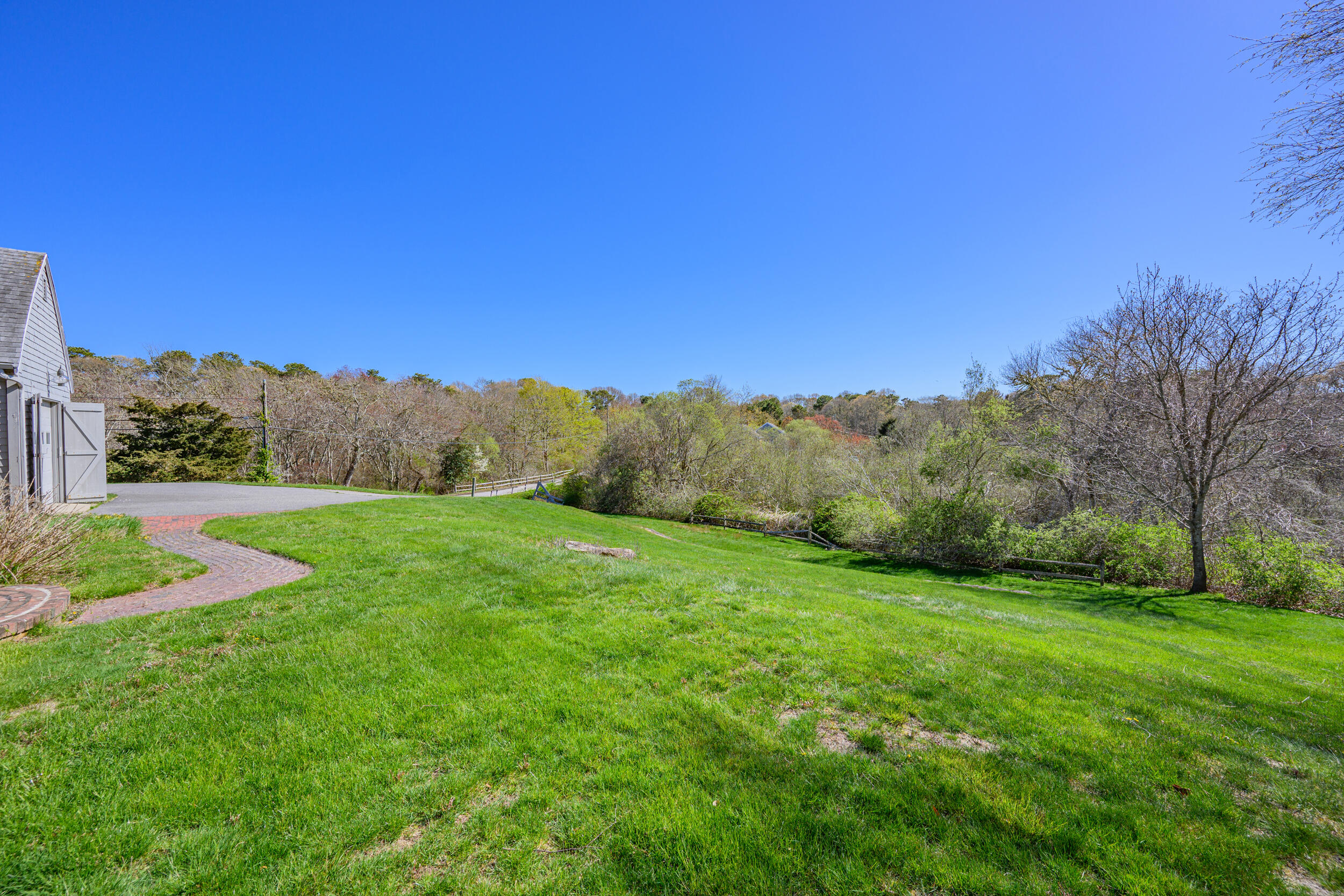 181 Elliott Road Centerville, MA 02632 - Photo 46 of 60 a view of a grassy field with trees in the background
