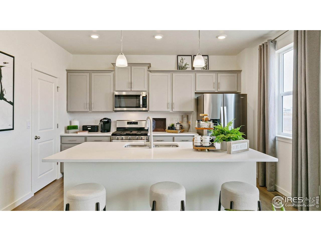 942 London Way Severance, CO 80550 - Photo 7 of 26 a kitchen with a sink stainless steel appliances and refrigerator