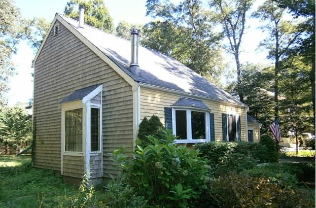 89 Pimlico Pond Road Mashpee, MA 02649 - Photo 11 of 14 a view of a white house next to a yard