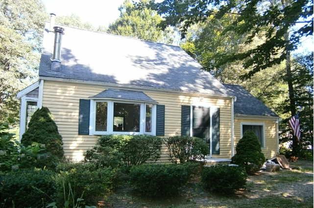 89 Pimlico Pond Road Mashpee, MA 02649 - Photo 13 of 14 a view of a house with brick walls and a large tree