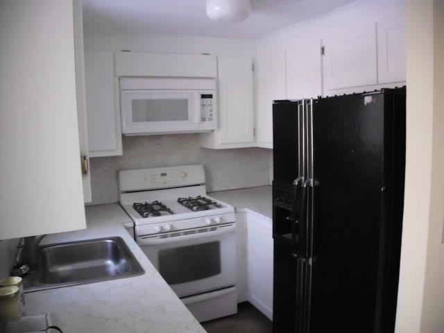 89 Pimlico Pond Road Mashpee, MA 02649 - Photo 2 of 14 a kitchen with a stove and a refrigerator