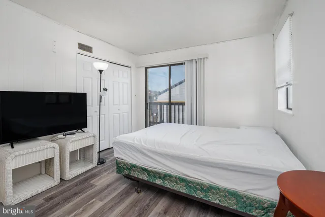 a bedroom with a bed and a night stand