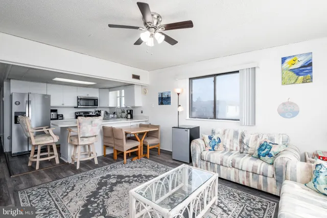 a view of kitchen with refrigerator a table and chairs
