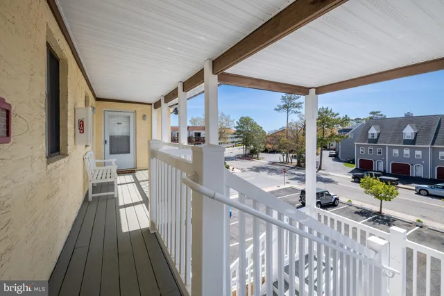 a view of a balcony with wooden floor and fence