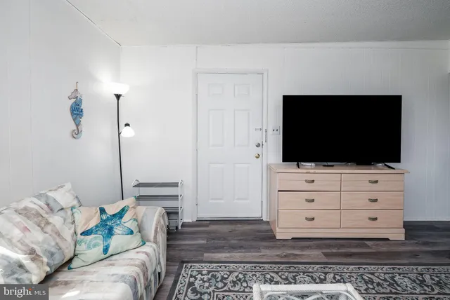 a bedroom with a bed and a flat tv screen