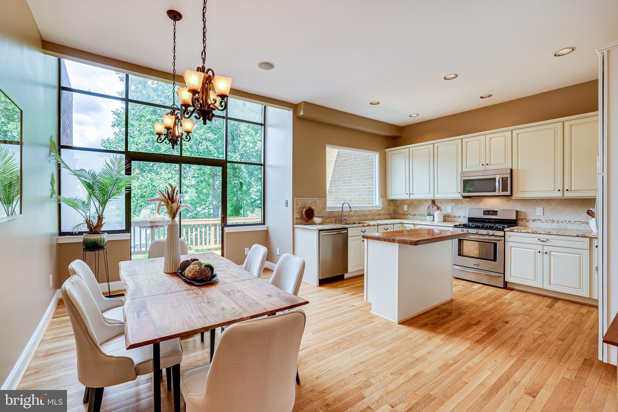 11056 Thrush Ridge Road Reston, VA 20191 - Photo 13 of 62 a kitchen with a table chairs a sink dishwasher window and cabinets
