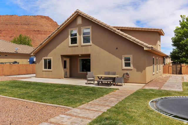 225 Falcon Court Ivins, UT 84738 - Photo 28 of 47 Rear view of property with a fenced backyard, stucco siding, a patio area, and a tile roof