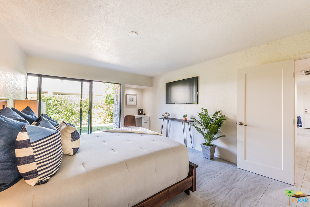 1111 East Ramon Road, Unit 8 Palm Springs, CA 92264 - Photo 11 of 36 a living room with furniture and a large window