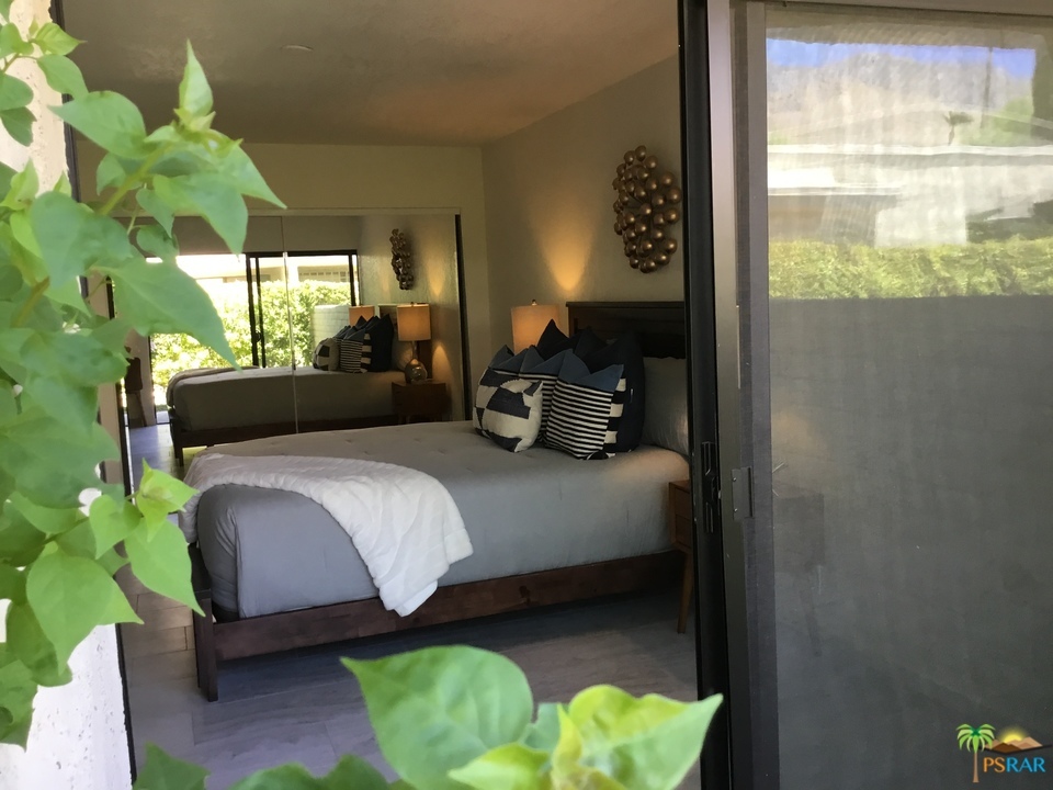 1111 East Ramon Road, Unit 8 Palm Springs, CA 92264 - Photo 13 of 36 a bedroom with a bed mirror and window