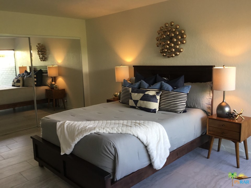 1111 East Ramon Road, Unit 8 Palm Springs, CA 92264 - Photo 15 of 36 a bedroom with a bed and wooden floor