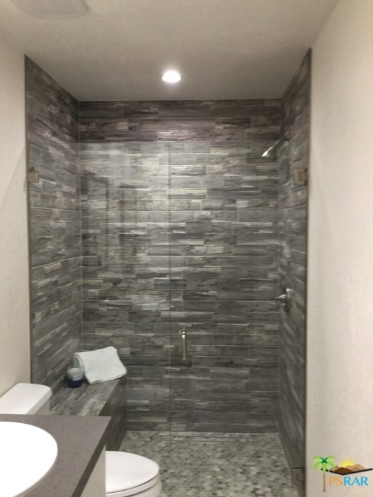 1111 East Ramon Road, Unit 8 Palm Springs, CA 92264 - Photo 19 of 36 a bathroom with a toilet and a shower