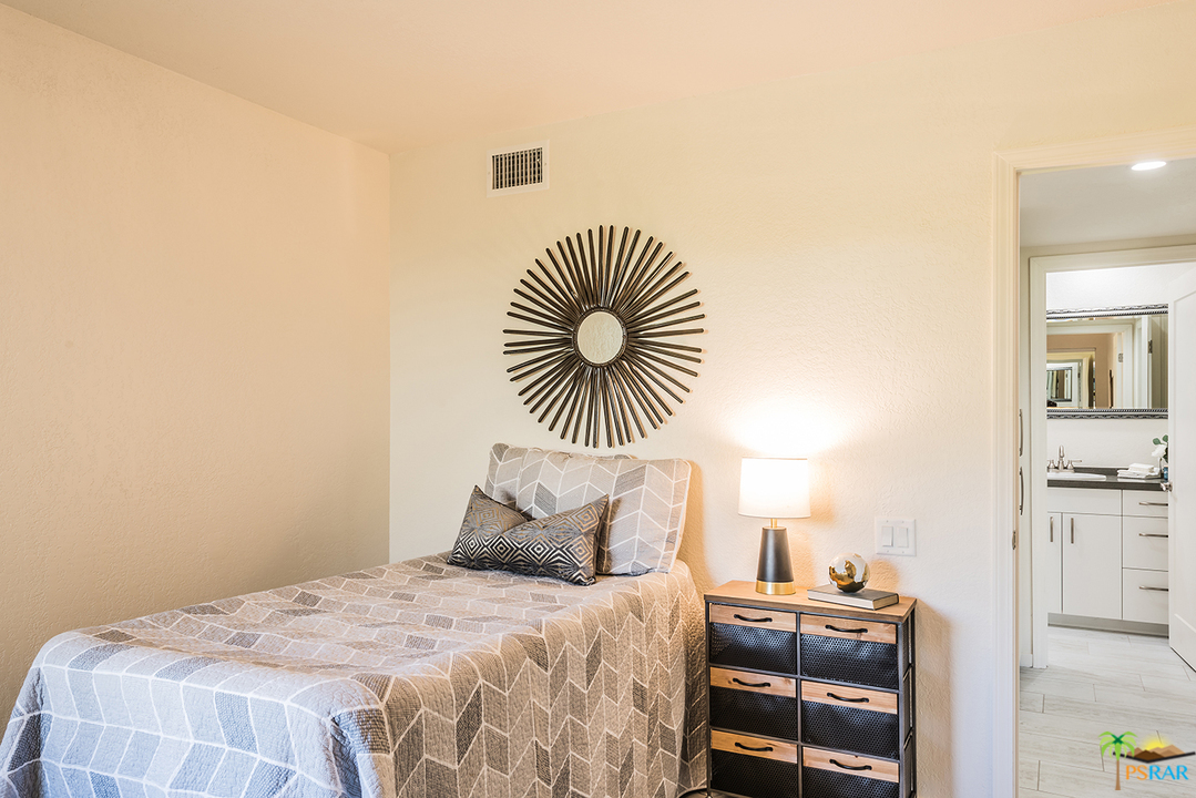 1111 East Ramon Road, Unit 8 Palm Springs, CA 92264 - Photo 23 of 36 a bedroom with a bed and a couch