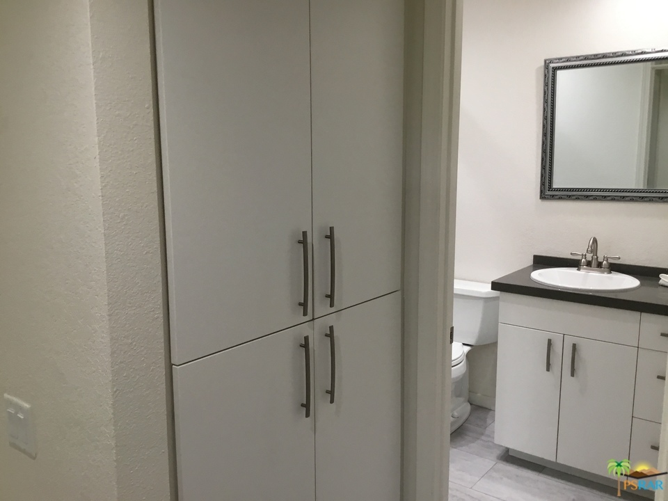 1111 East Ramon Road, Unit 8 Palm Springs, CA 92264 - Photo 25 of 36 a bathroom with a sink and a mirror