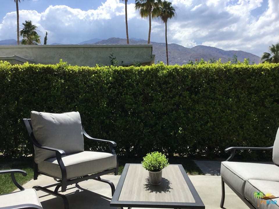 1111 East Ramon Road, Unit 8 Palm Springs, CA 92264 - Photo 28 of 36 a view of a chair and table on the terrace