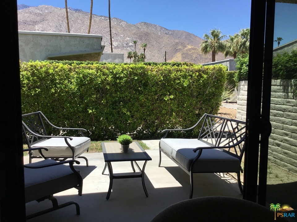 1111 East Ramon Road, Unit 8 Palm Springs, CA 92264 - Photo 29 of 36 a view of a patio with table and chairs and potted plants