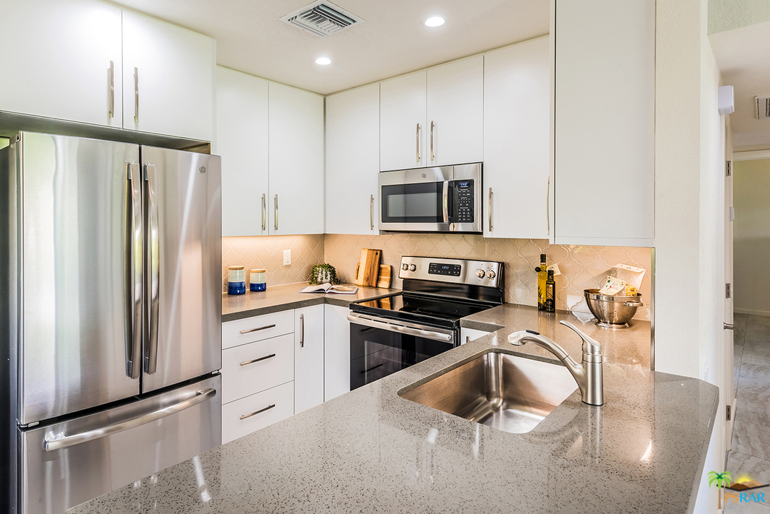 1111 East Ramon Road, Unit 8 Palm Springs, CA 92264 - Photo 8 of 36 a kitchen with a refrigerator stove and microwave