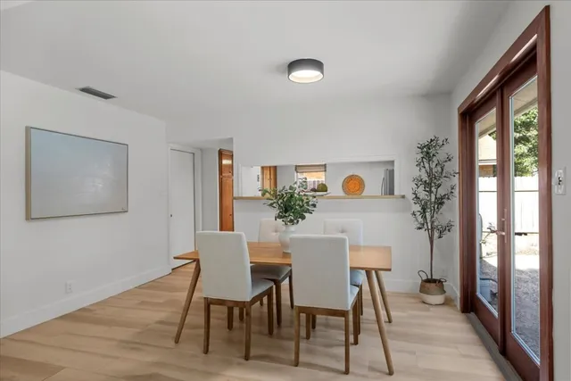 a view of a dining room with furniture and window