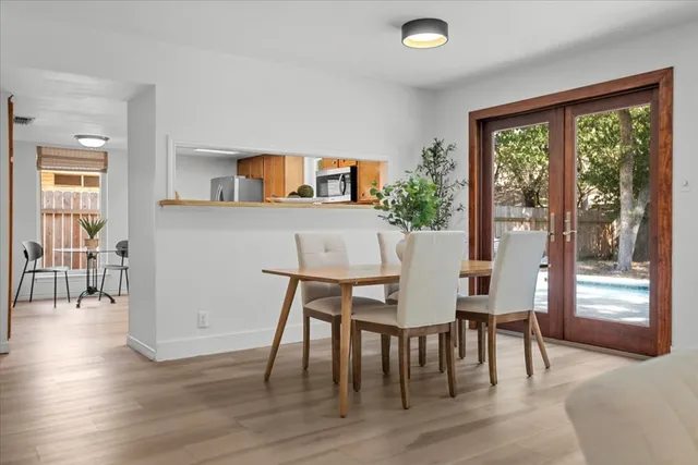 a view of a dining room with furniture window and wooden floor