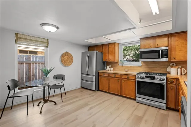 a kitchen with stainless steel appliances granite countertop a stove and a refrigerator