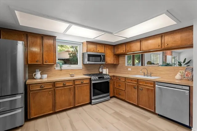 a kitchen with stainless steel appliances granite countertop a stove and a sink
