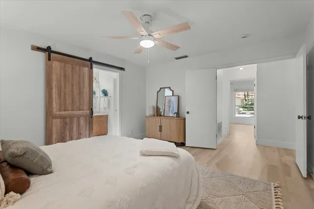 a bedroom with a large bed and a chandelier