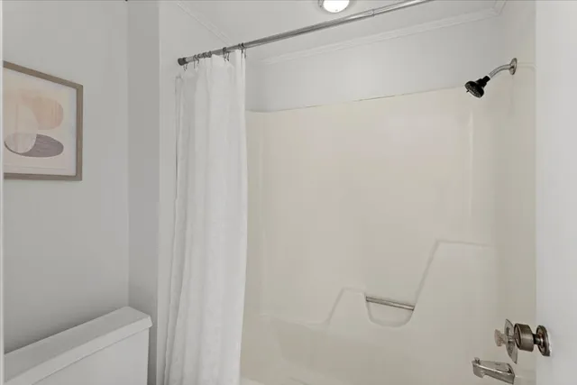 a bathroom with a shower and a toilet