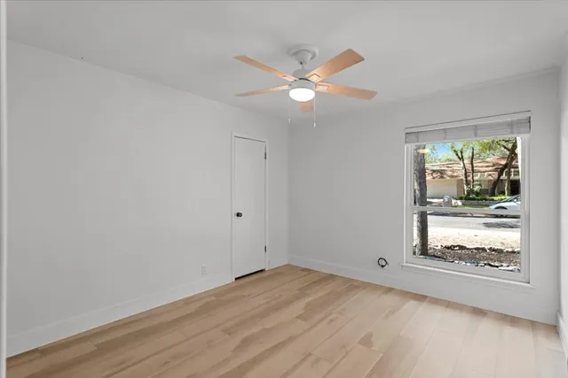 wooden floor in an empty room and a window