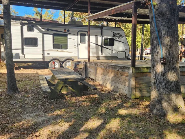 a backyard of a house with table and chairs