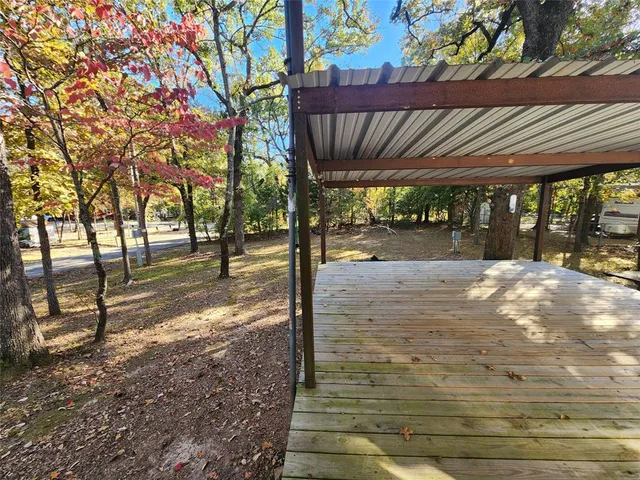 a view of a yard with wooden fence