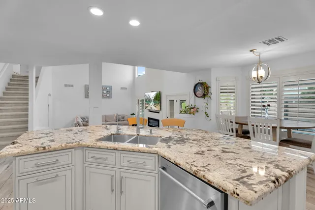 a view of a dining room with furniture wooden floor and a chandelier