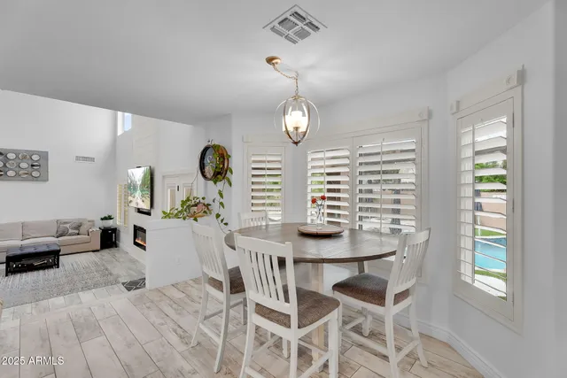 a view of a livingroom with workspace and a ceiling fan