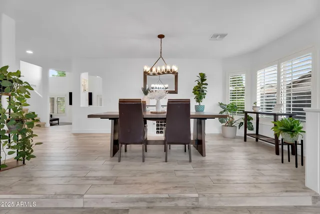 a living room with furniture and a ceiling fan