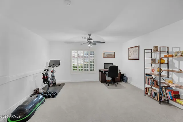 a spacious bedroom with a large bed and a large window