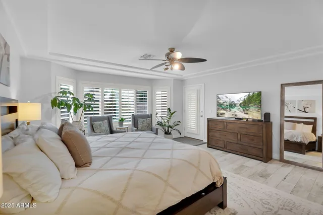 a bedroom with a bed and a chandelier