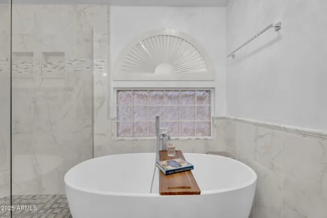 a bedroom with furniture and a large window