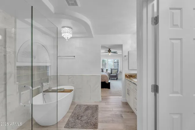 a bathroom with a granite countertop sink a toilet a mirror and shower