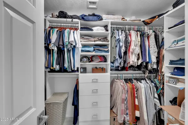 a view of a kitchen with stainless steel appliances wooden floor and a window