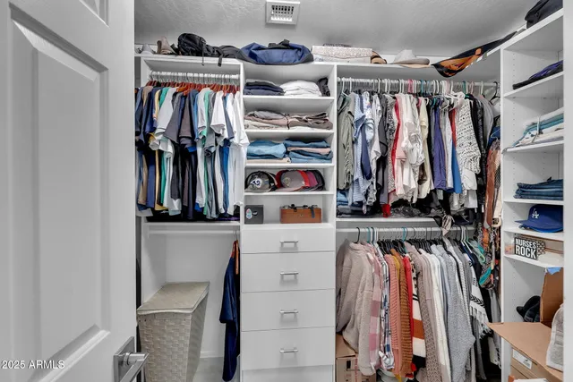 a view of a kitchen with stainless steel appliances wooden floor and a window