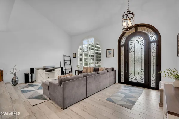 a living room with furniture and a large mirror