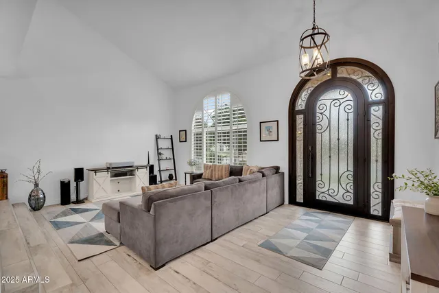 a living room with furniture and a large mirror