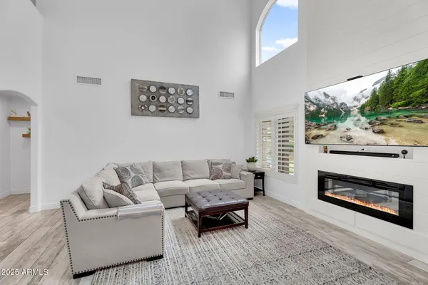 a living room with furniture and a fireplace