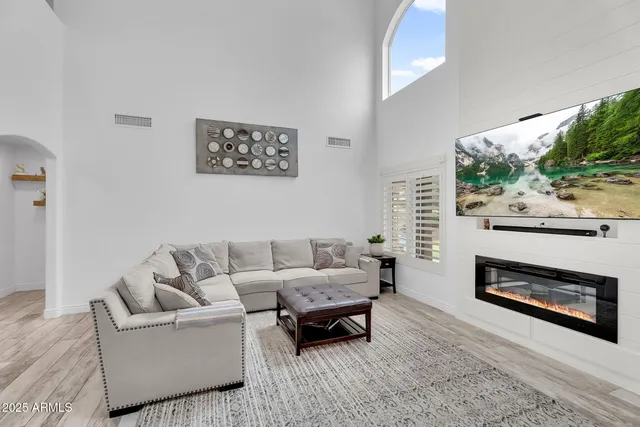 a living room with furniture and a fireplace