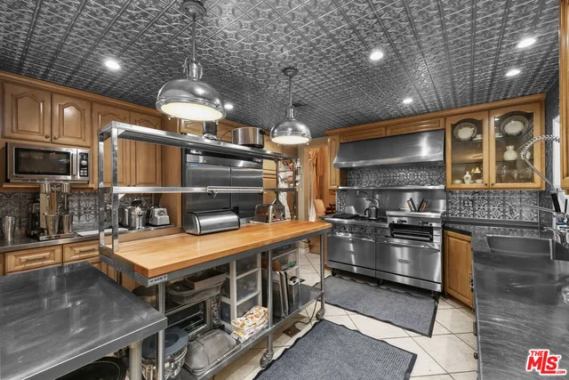 a kitchen with stainless steel appliances granite countertop a stove and a sink