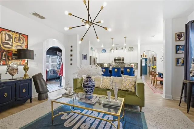 a living room with furniture and wooden floor
